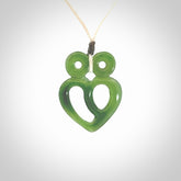 This is a handcarved love heart pendant made from a gorgeous and striking piece of British Columbia Jade stone. This is a superbly carved and very unique piece if custom jewellery. For sale online from NZ Pacific.